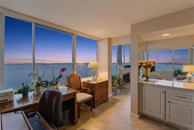 a living room with furniture a large window and a flat screen tv