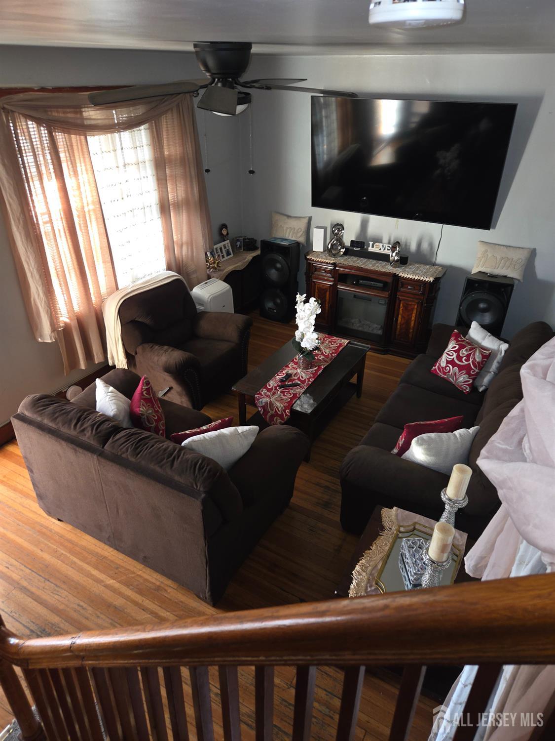 552 Compton Avenue Perth Amboy, NJ 08861 - Photo 3 of 13 a living room with furniture and a flat screen tv