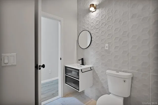 a bathroom with a sink a toilet and a shower
