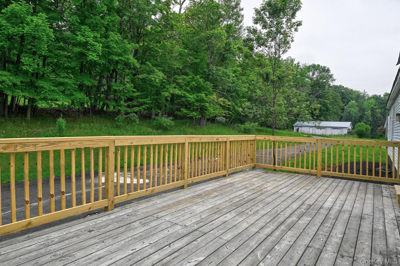 386 Airport Road Liberty, NY 12754 - Photo 16 of 21 a view of a wooden deck with a yard