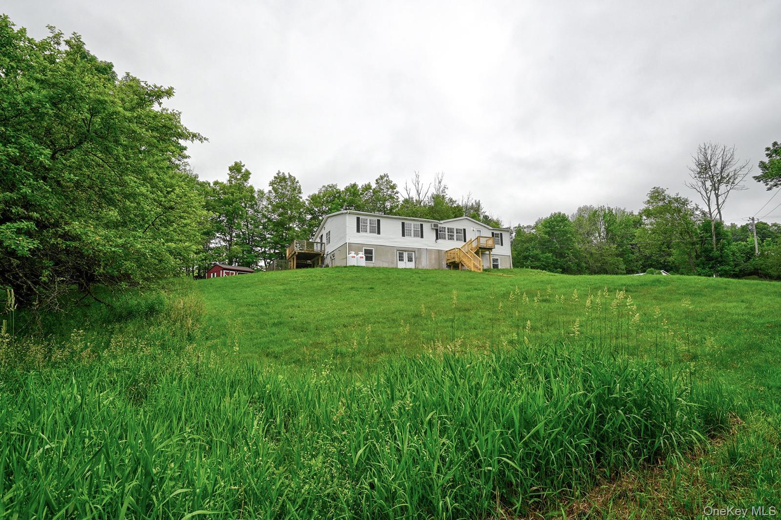 386 Airport Road Liberty, NY 12754 - Photo 2 of 21 a view of a house with a big yard and large trees