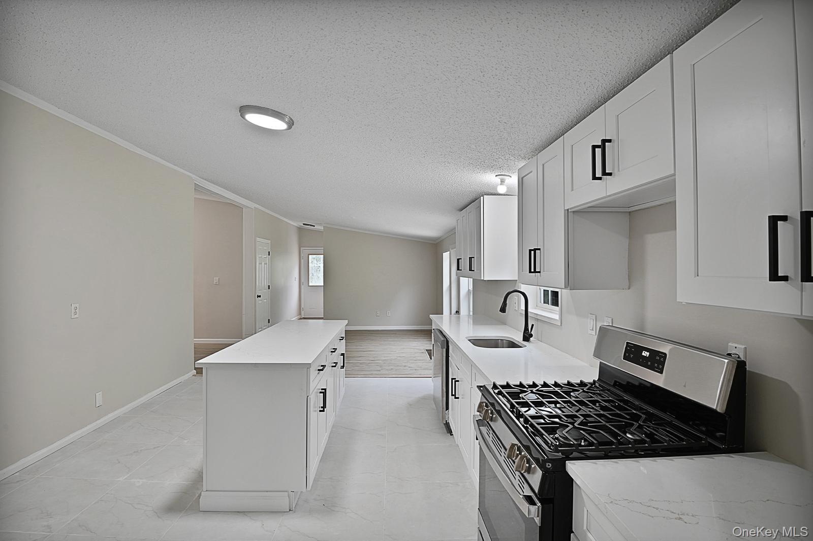 386 Airport Road Liberty, NY 12754 - Photo 10 of 21 a kitchen with white cabinets and stove