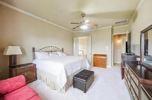 a view of a big house with a big yard and large trees