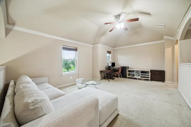 a living room with furniture large window and a fireplace