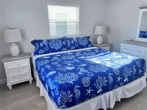 a bedroom with a bed a lamp and closet