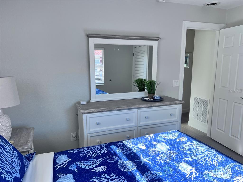 6154 Midnight Pass Road, Unit A11 Sarasota, FL 34242 - Photo 12 of 22 a bedroom with a bed and a dresser in it