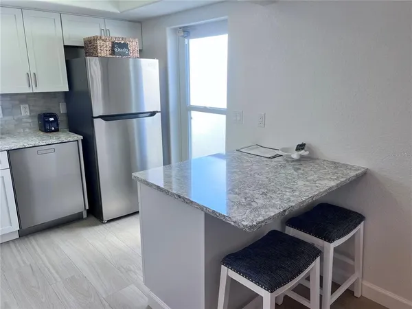 a kitchen with a table and refrigerator