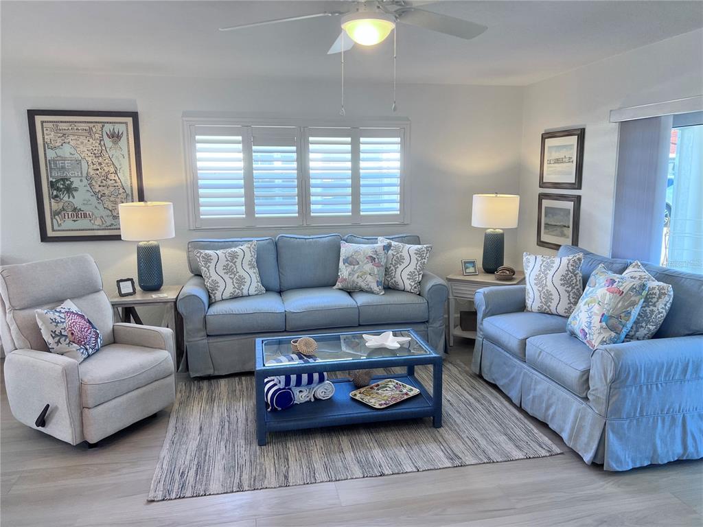6154 Midnight Pass Road, Unit A11 Sarasota, FL 34242 - Photo 5 of 22 a living room with furniture and a lamp