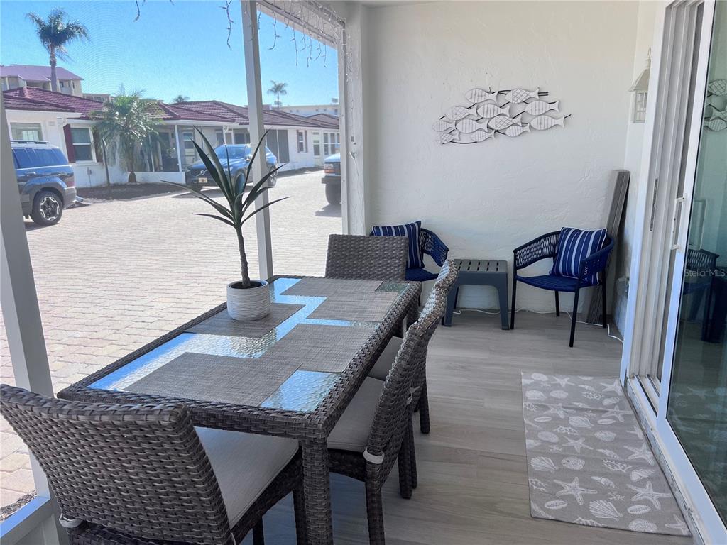 6154 Midnight Pass Road, Unit A11 Sarasota, FL 34242 - Photo 9 of 22 a view of a dining room with furniture and wooden floor