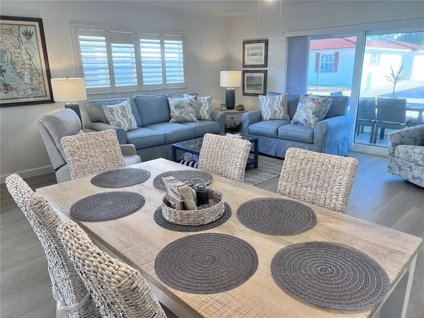 a living room with furniture a rug and a window