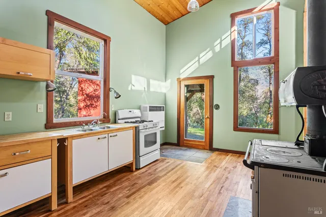 a view of a room with wooden floor and windows