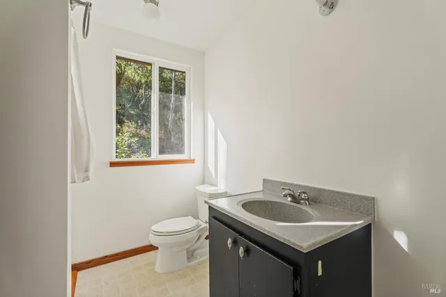 a backyard of a house with fountain table and chairs