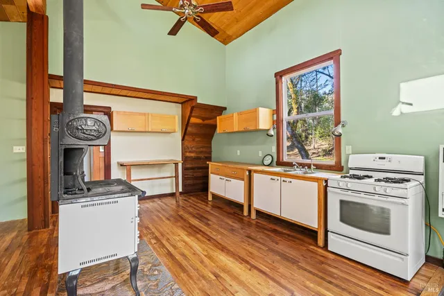 a kitchen with a sink and wooden floor