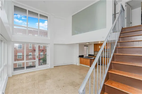 an entryway with wooden floor and stairs