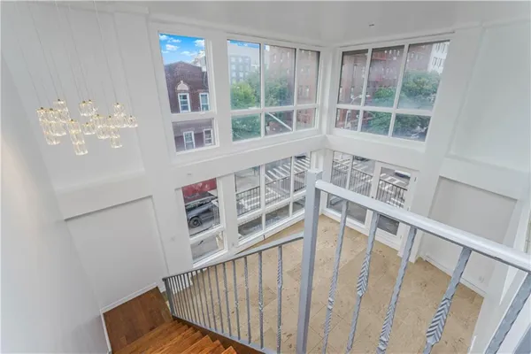 a view of staircase with railing and white walls