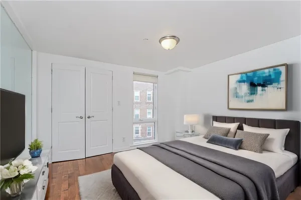 a spacious bedroom with a bed and a couch