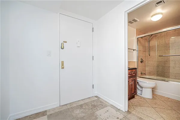 a bathroom with a toilet and a shower