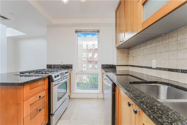 a kitchen that has a sink and a stove