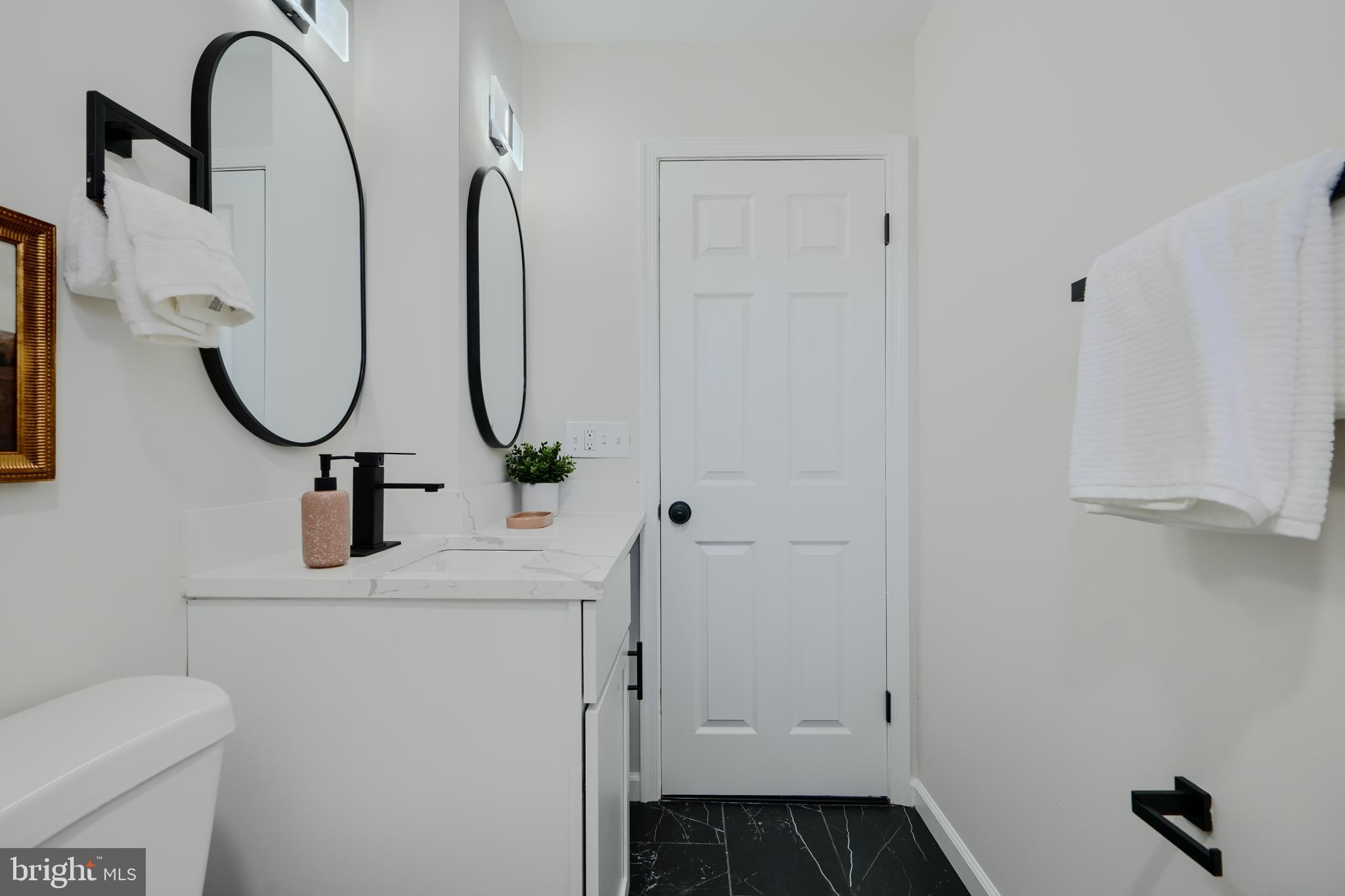 1836 Colmar Road Baltimore, MD 21207 - Photo 31 of 47 a bathroom with a sink and mirror