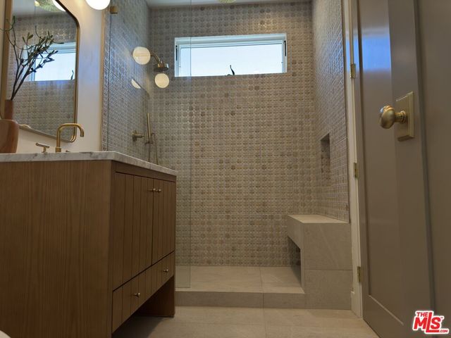 a bathroom with a shower and a sink