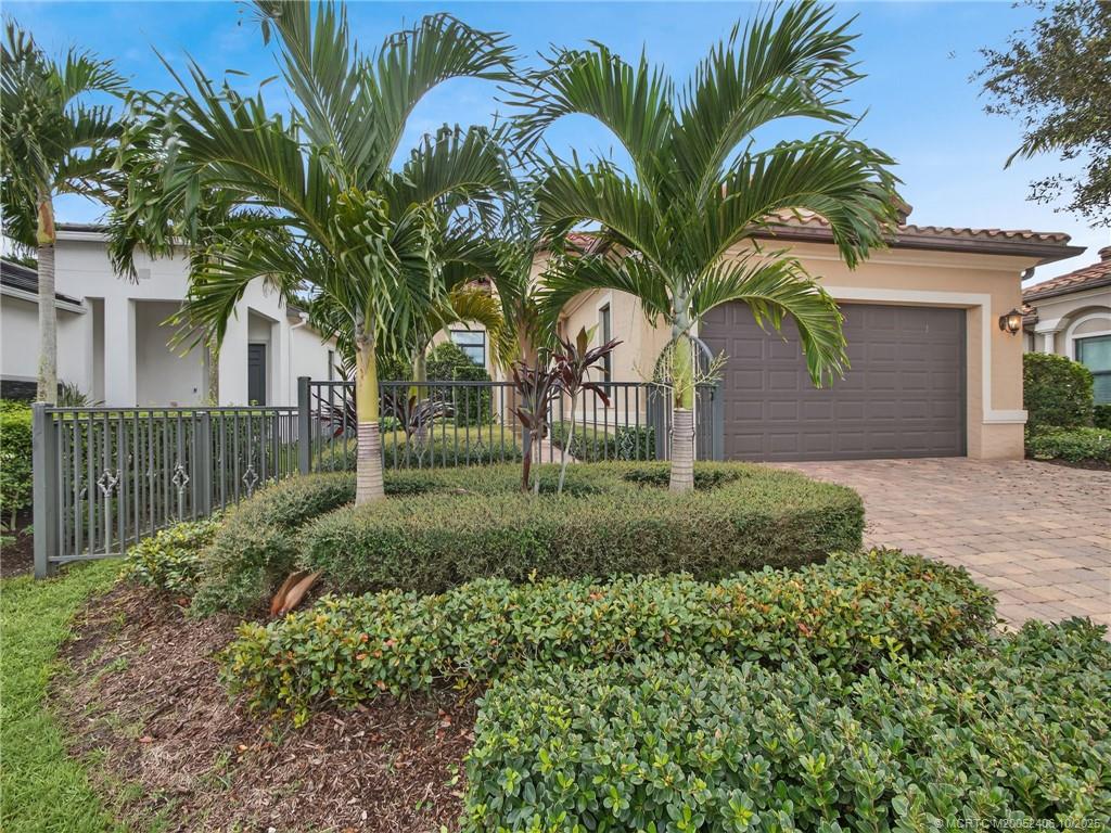 600 Southeast Fascino Circle Port St. Lucie, FL 34984 - Photo 1 of 22 a view of a white house with a small yard and plants