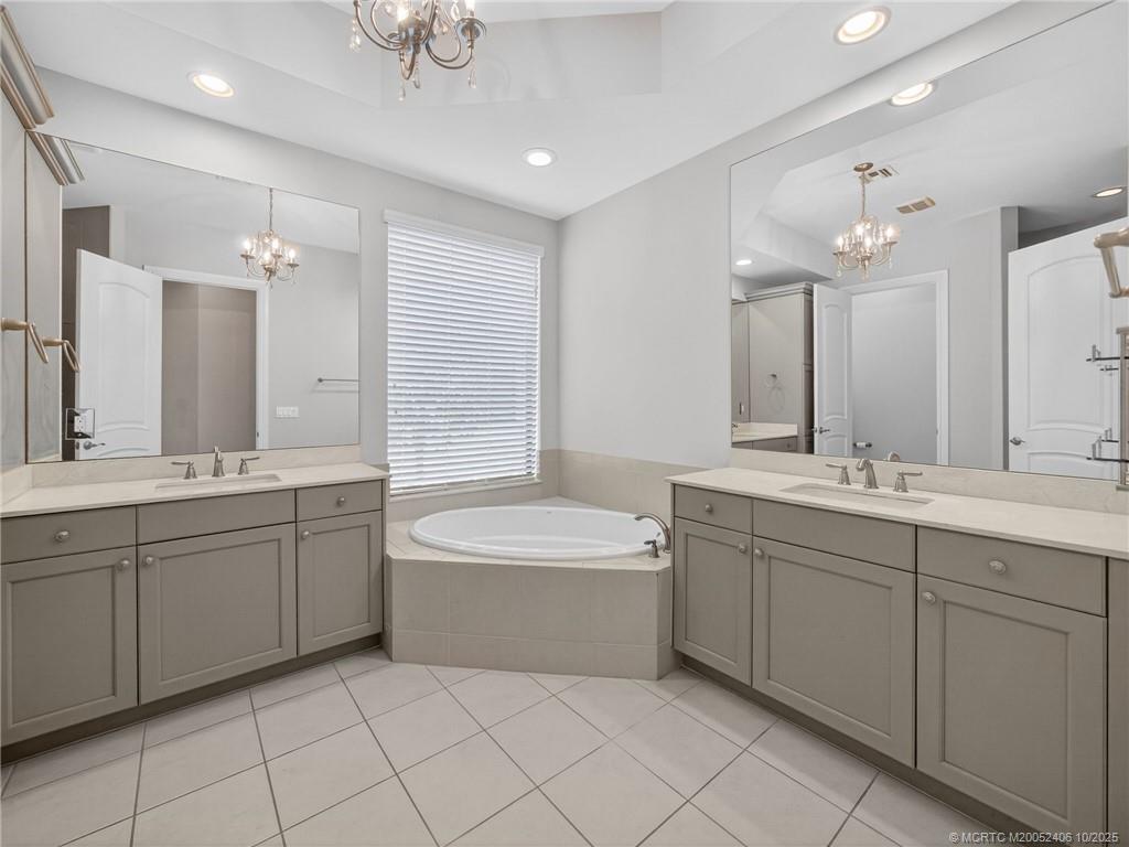 600 Southeast Fascino Circle Port St. Lucie, FL 34984 - Photo 14 of 22 a bathroom with a double vanity sink mirror and bathtub