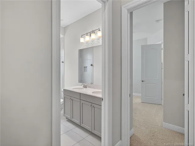a bathroom with a granite countertop toilet sink and mirror