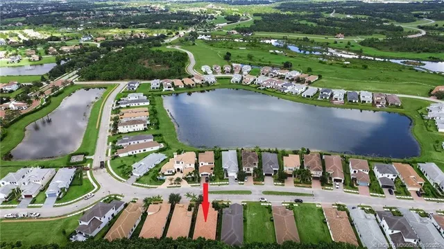 an aerial view of residential houses with outdoor space and street view