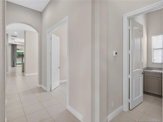 an empty room with chandelier fan