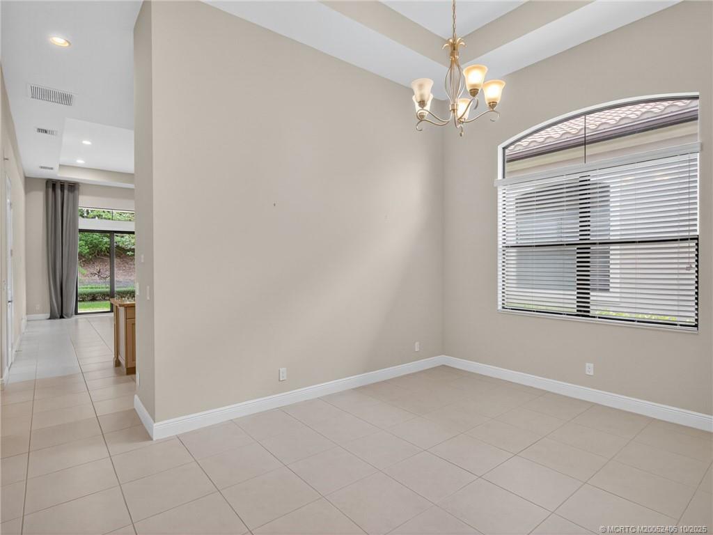 600 Southeast Fascino Circle Port St. Lucie, FL 34984 - Photo 6 of 22 wooden floor in an empty room with a window