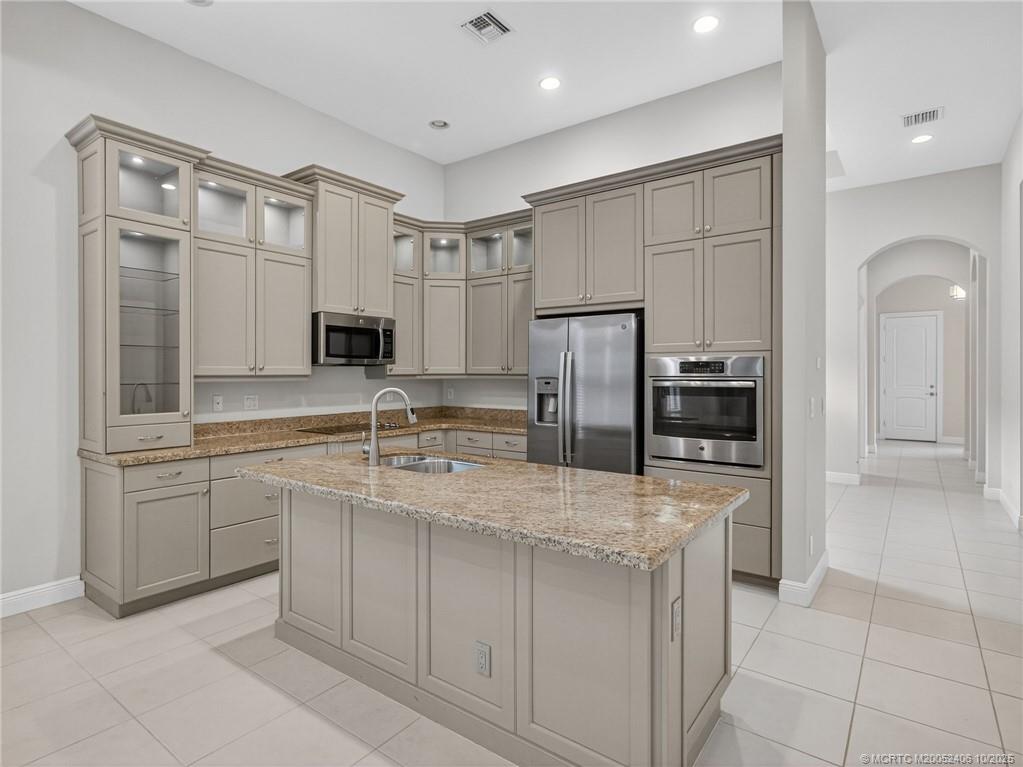 600 Southeast Fascino Circle Port St. Lucie, FL 34984 - Photo 7 of 22 a kitchen with stainless steel appliances granite countertop a refrigerator and a sink