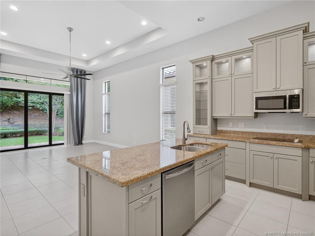 600 Southeast Fascino Circle Port St. Lucie, FL 34984 - Photo 8 of 22 a kitchen with a sink stove and cabinets