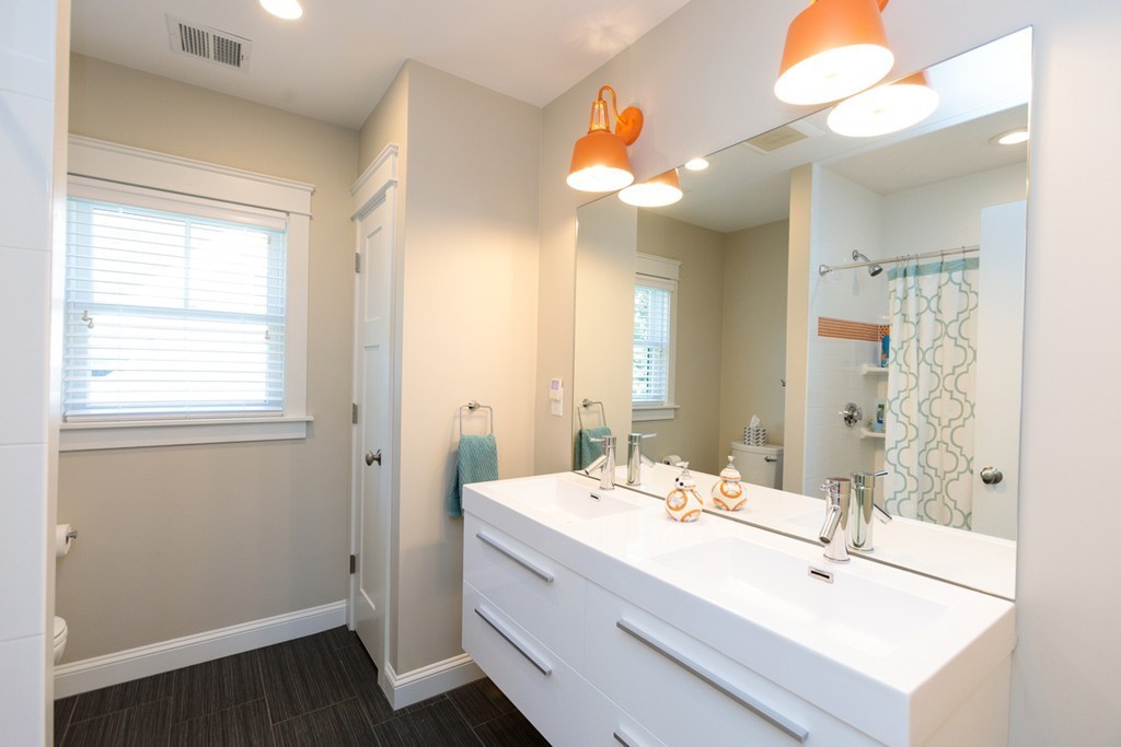 74 Hillcrest Road Needham, MA 02492 - Photo 23 of 29 a bathroom with a sink a large mirror and vanity