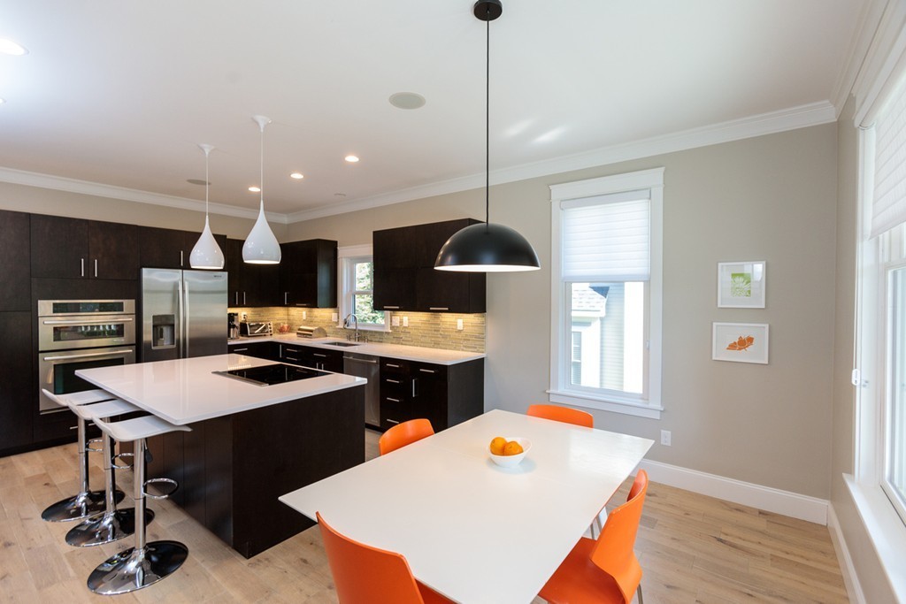 74 Hillcrest Road Needham, MA 02492 - Photo 10 of 29 a kitchen with a sink a stove a refrigerator and chairs