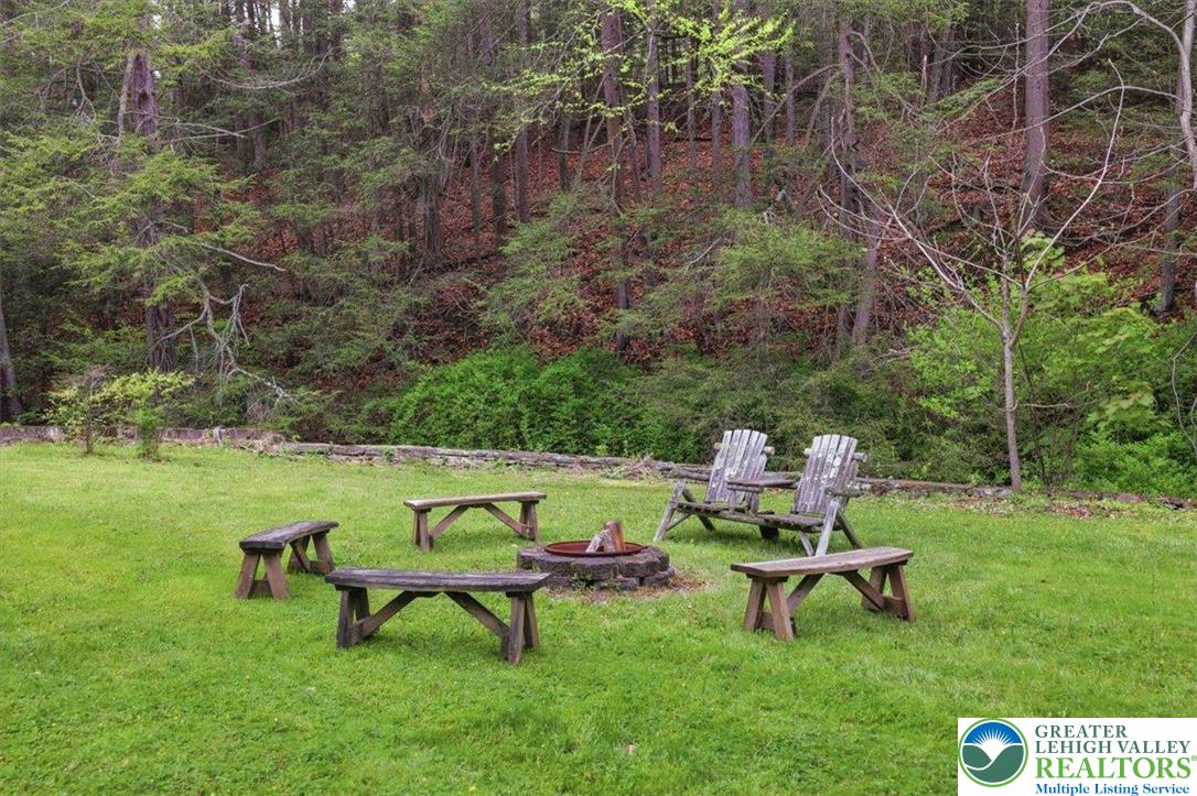 3585 Fairyland Road Lehighton, PA 18235 - Photo 56 of 57 a view of a bench in the garden near a lake