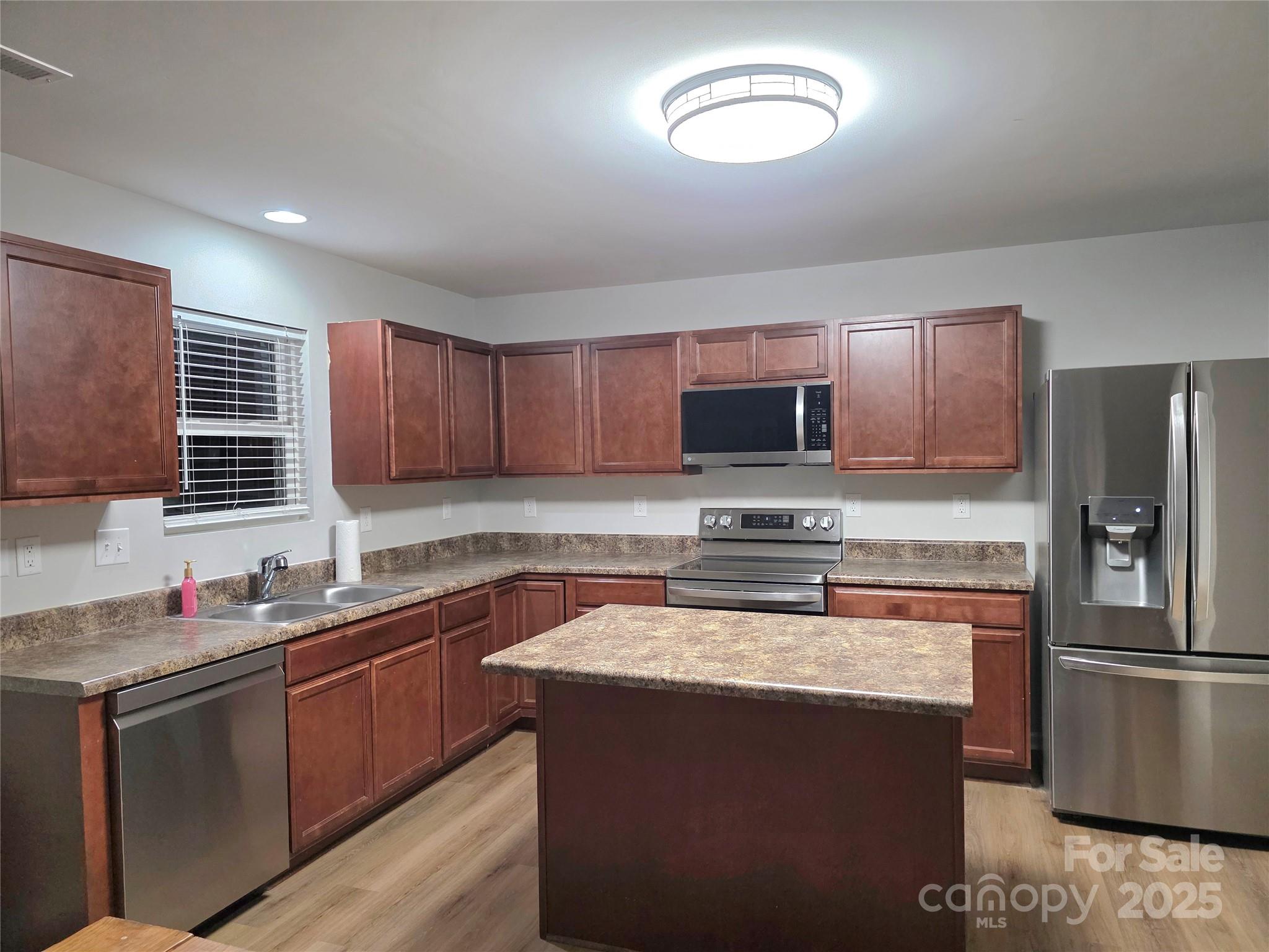 1047 Mackey Court Gastonia, NC 28056 - Photo 23 of 30 a kitchen with stainless steel appliances granite countertop a sink stove microwave and refrigerator