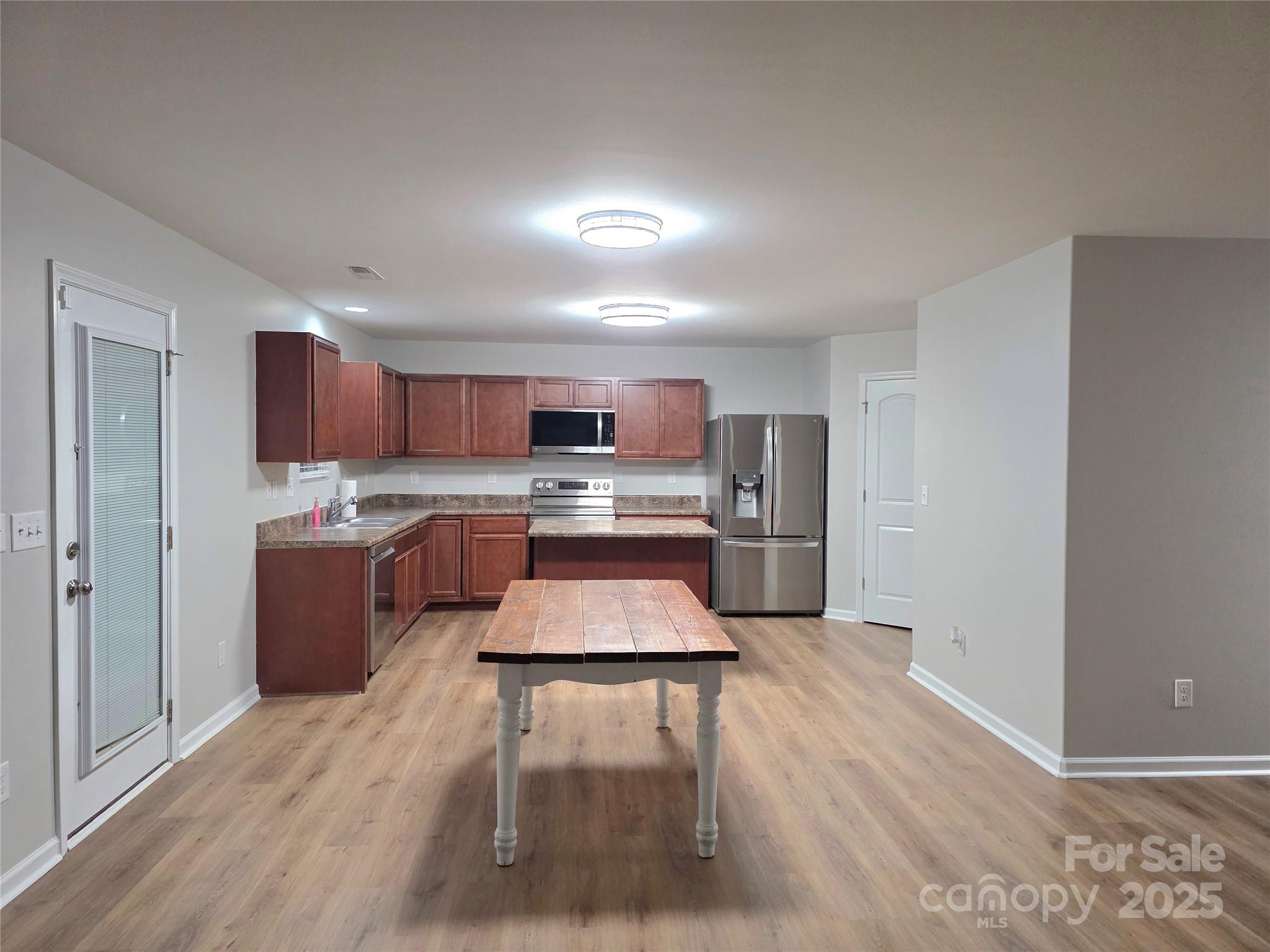 1047 Mackey Court Gastonia, NC 28056 - Photo 24 of 30 a kitchen with stainless steel appliances granite countertop a refrigerator sink and cabinets