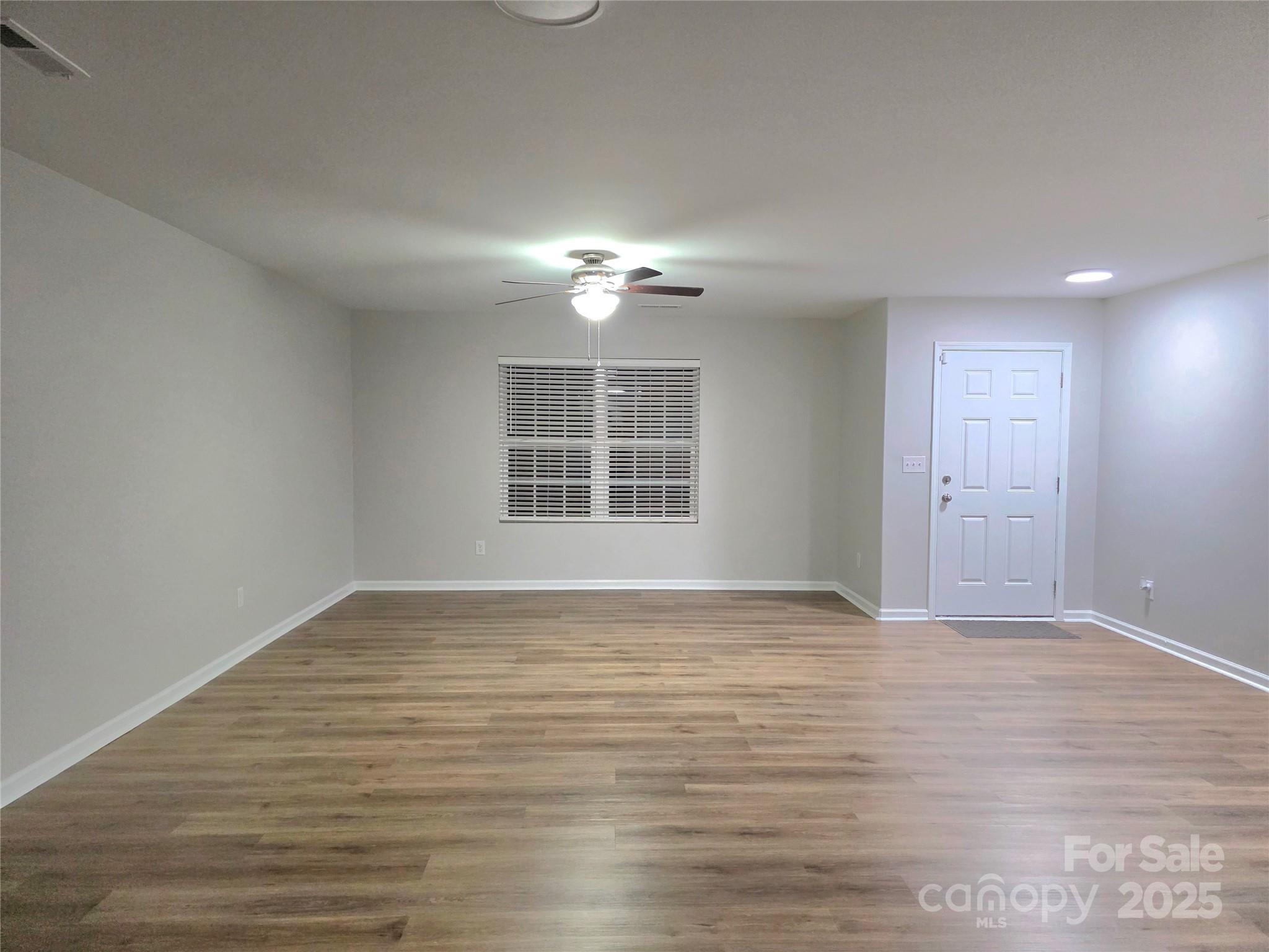 1047 Mackey Court Gastonia, NC 28056 - Photo 27 of 30 a view of empty room with wooden floor and fan