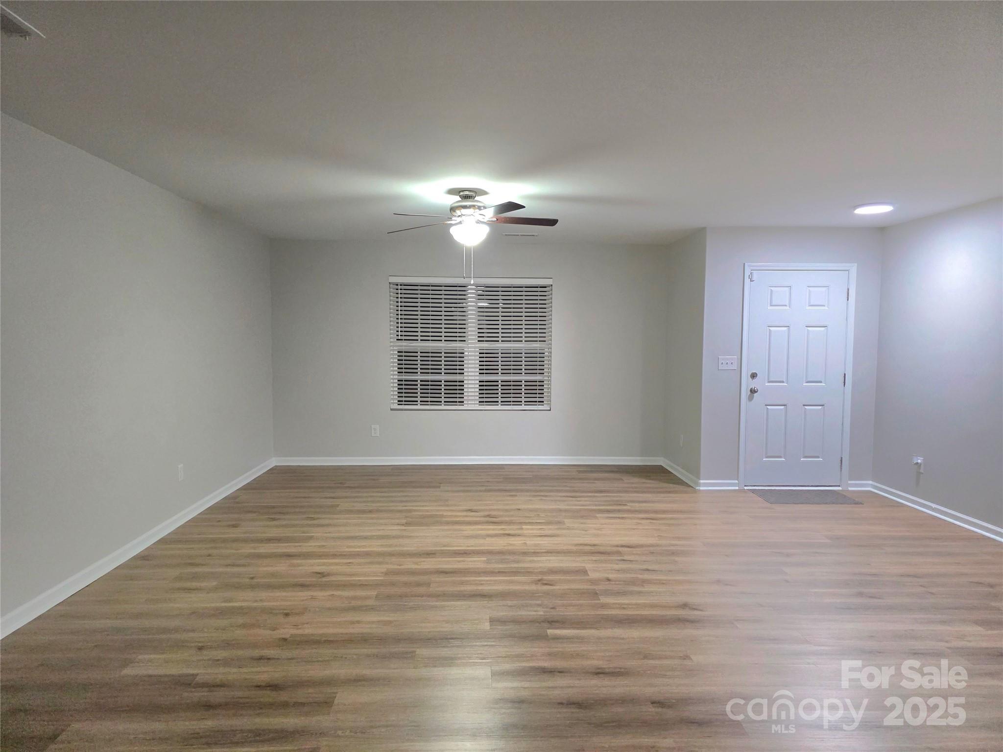 1047 Mackey Court Gastonia, NC 28056 - Photo 5 of 30 a view of empty room with wooden floor and fan