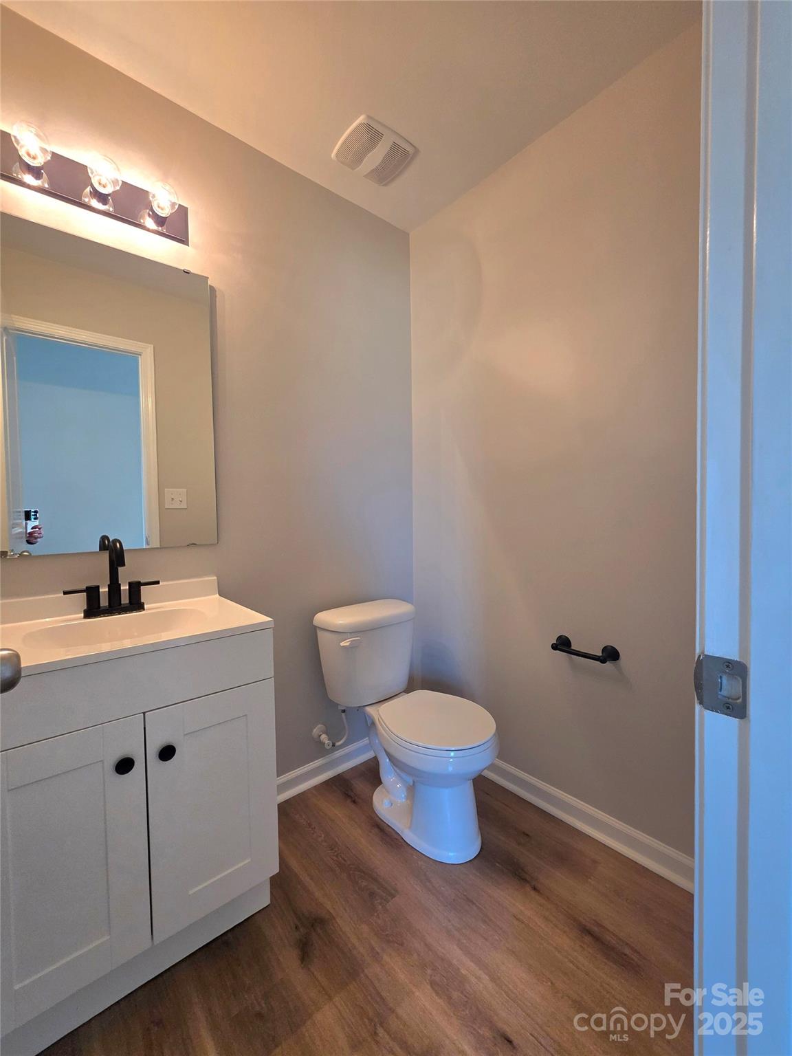 1047 Mackey Court Gastonia, NC 28056 - Photo 7 of 30 a bathroom with a toilet a sink a mirror and vanity