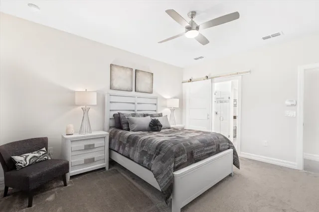 a bedroom with a bed and a couch