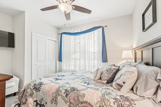 a bedroom with a large bed and a window