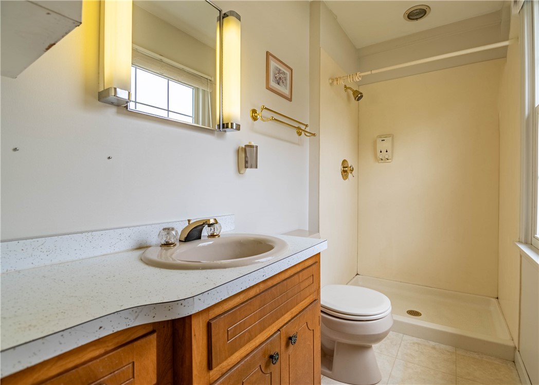 365 West Ash Avenue Decatur, IL 62526 - Photo 18 of 32 a bathroom with a sink a toilet and shower