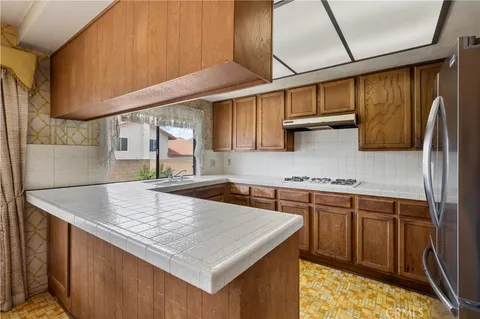 a kitchen with stainless steel appliances granite countertop a sink stove and cabinets