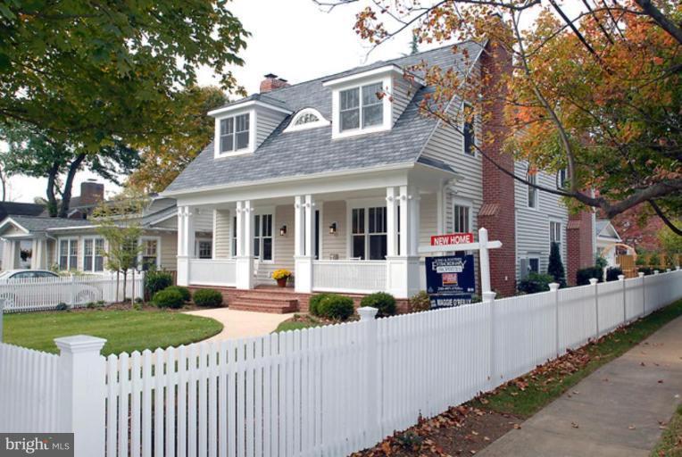 7816 Maple Ridge Road Bethesda, MD 20814 - Photo 1 of 16 a view of a house with a small yard and large trees