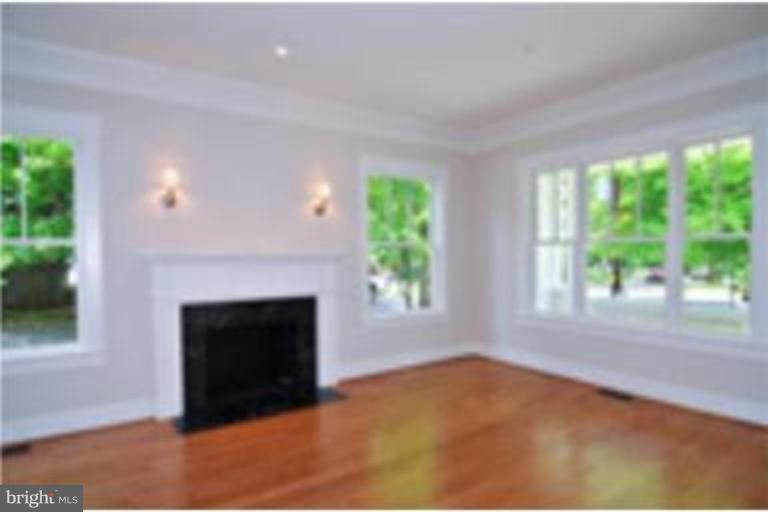 7816 Maple Ridge Road Bethesda, MD 20814 - Photo 10 of 16 an empty room with windows and fireplace