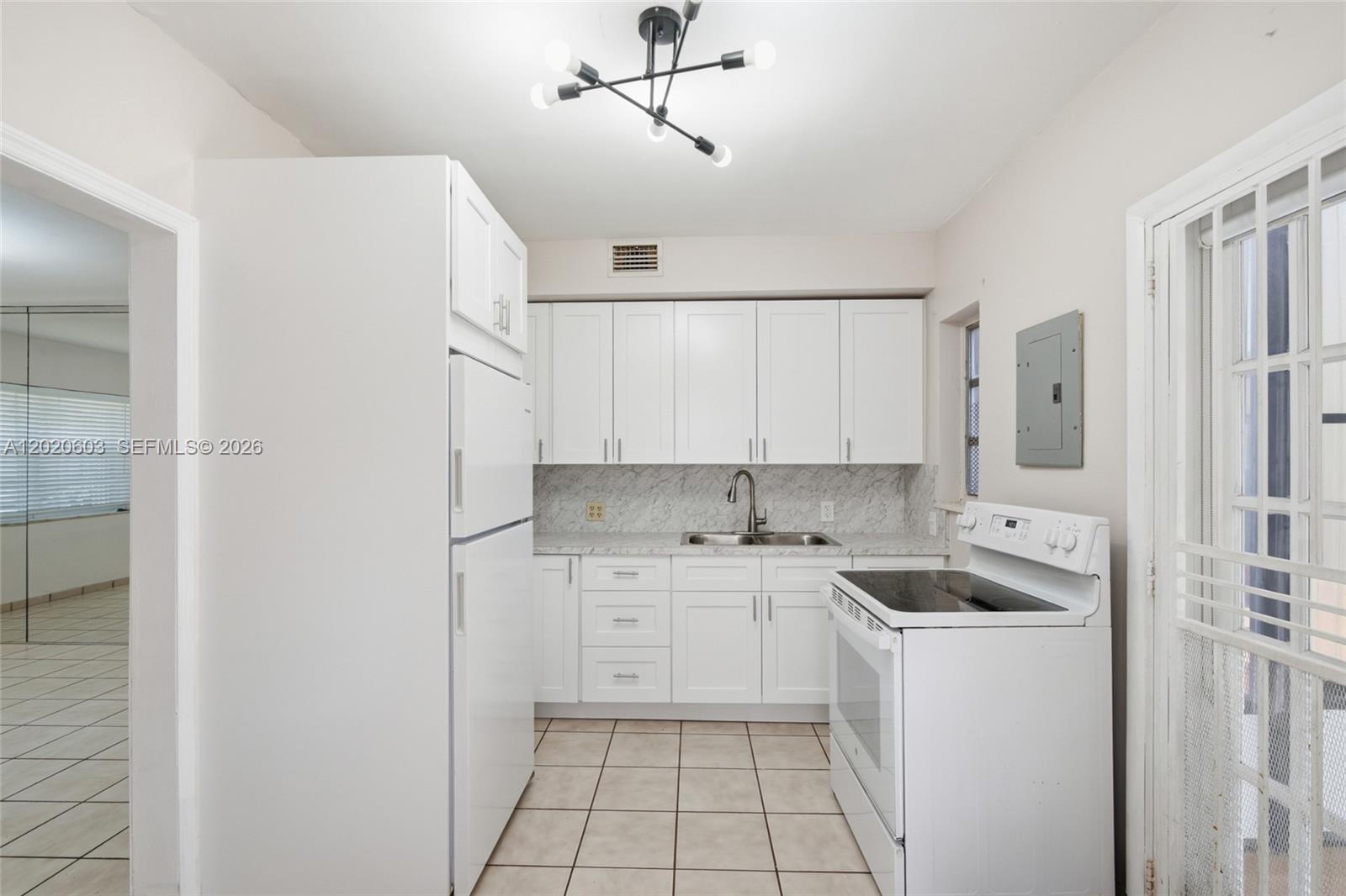 3750 Southwest 27th Street Miami, FL 33134 - Photo 8 of 41 a kitchen with a sink cabinets and refrigerator