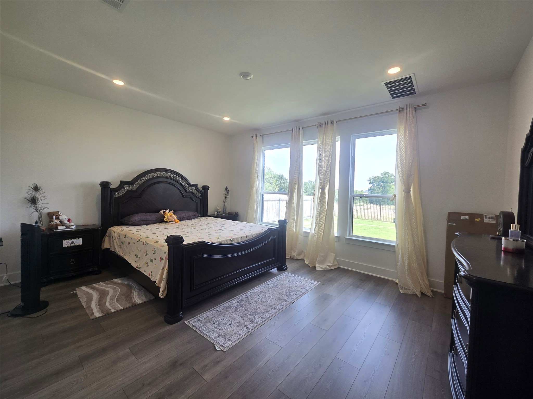 124 Ribera Drive Liberty Hill, TX 78642 - Photo 12 of 40 Recessed lighting illuminates this bedroom with ample natural light from multiple windows.