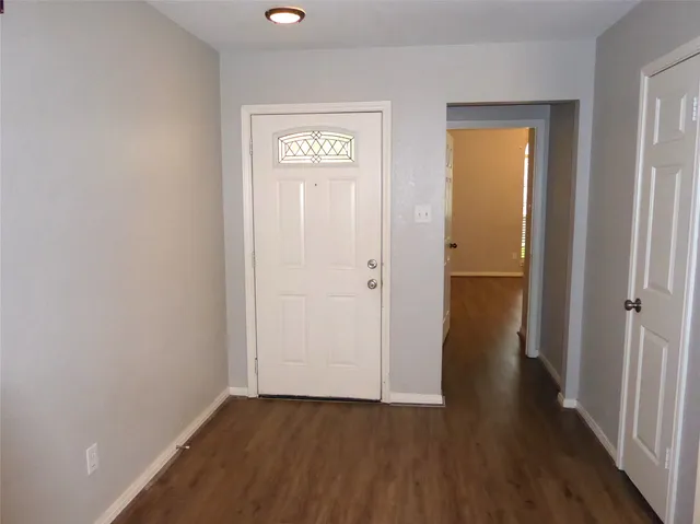 an empty room with wooden floor and closet