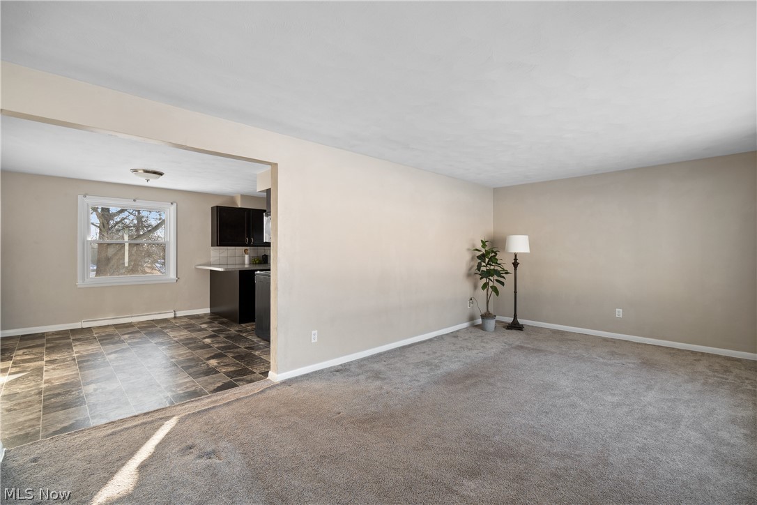 136 South Metzger Avenue Rittman, OH 44270 - Photo 6 of 33 Spare room featuring dark carpet and baseboards